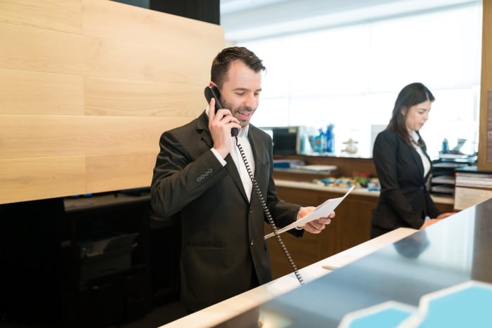Rezeptionist im Hotel telefoniert